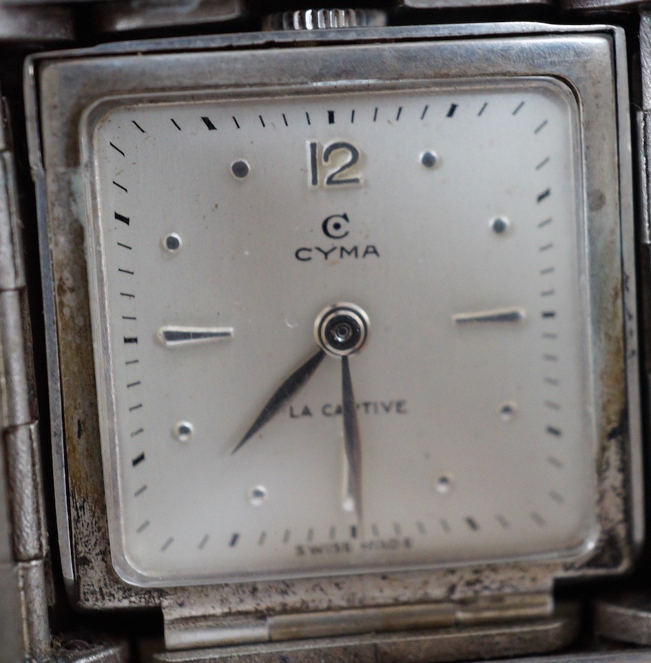 A mid 20th century 925 Cyma La Captive travelling watch, with 'rising sun' decoration, 47mm, in Bornand & Cie fitted leather case.